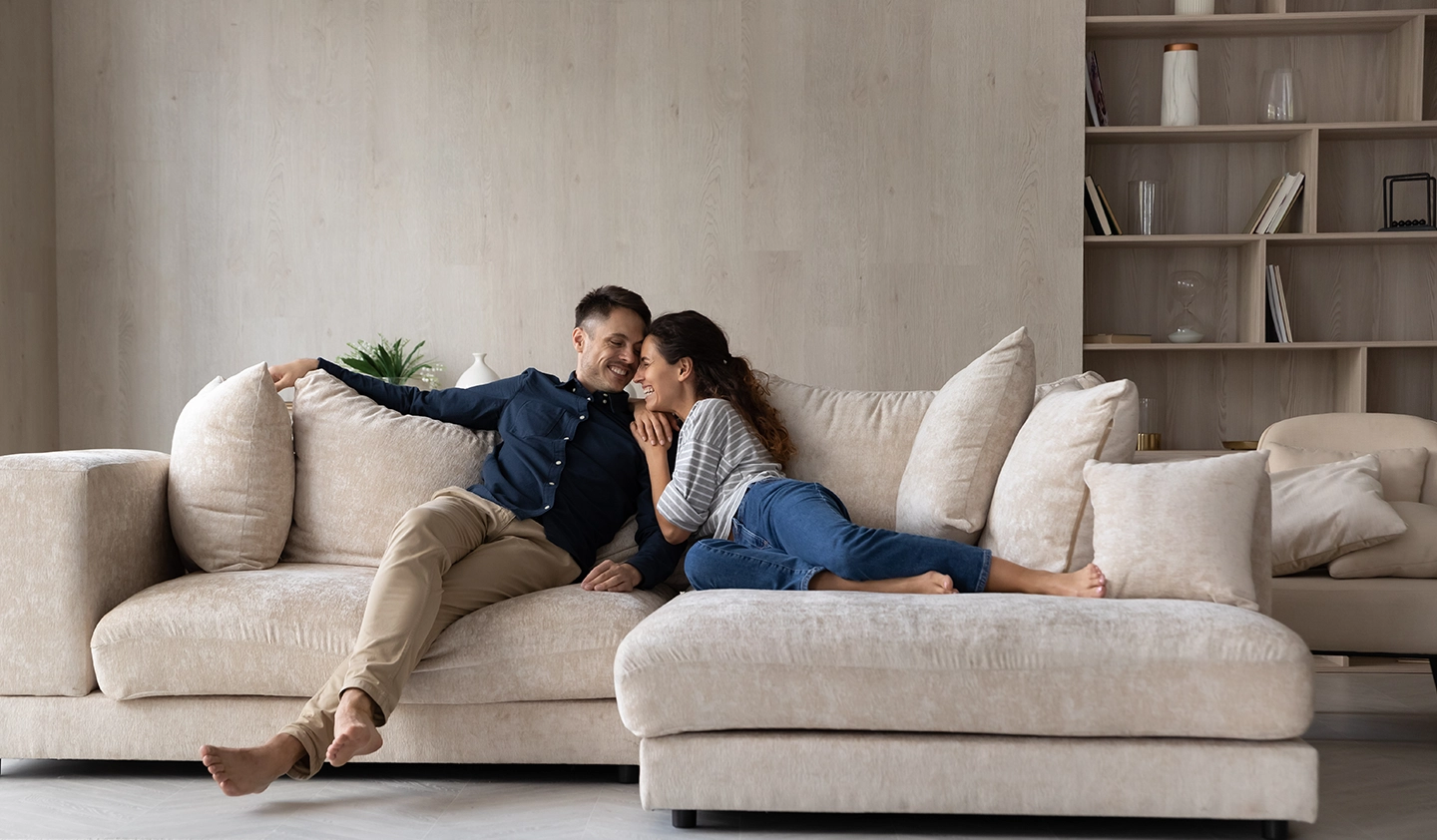 Smiling couple on sofa